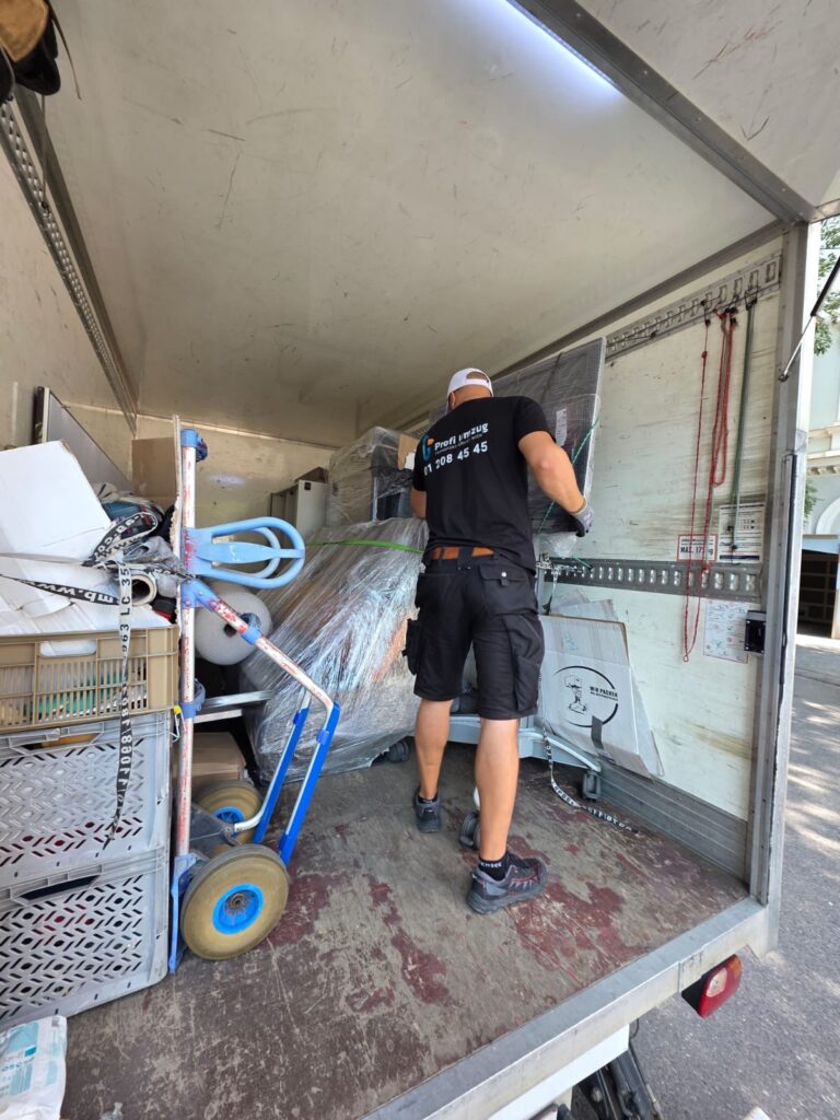 Mitarbeiter von Profi Umzug sichert Möbel im Laderaum des LKW, Umzug Korneuburg